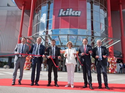 Mehrere Personen stehen für ein Gruppenfoto vor der neuen Kika-Filiale.