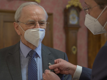 Bürgermeister Stadler steckt die Radhausnadel an Herrn Rottenschlagers Jackett.