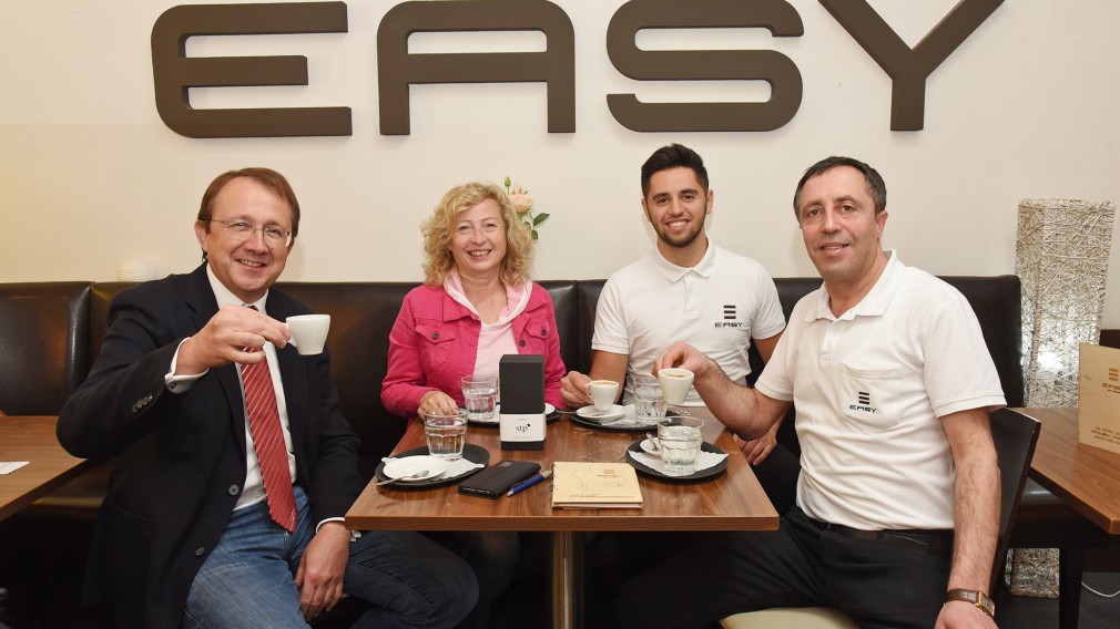 Bürgermeister Matthias Stadler und Bundesrätin Eva Prischl gratulieren Azem und Embrli Ziberi zum Jubiläum „15 Jahre Cafe Easy“. (Foto: Josef Vorlaufer)