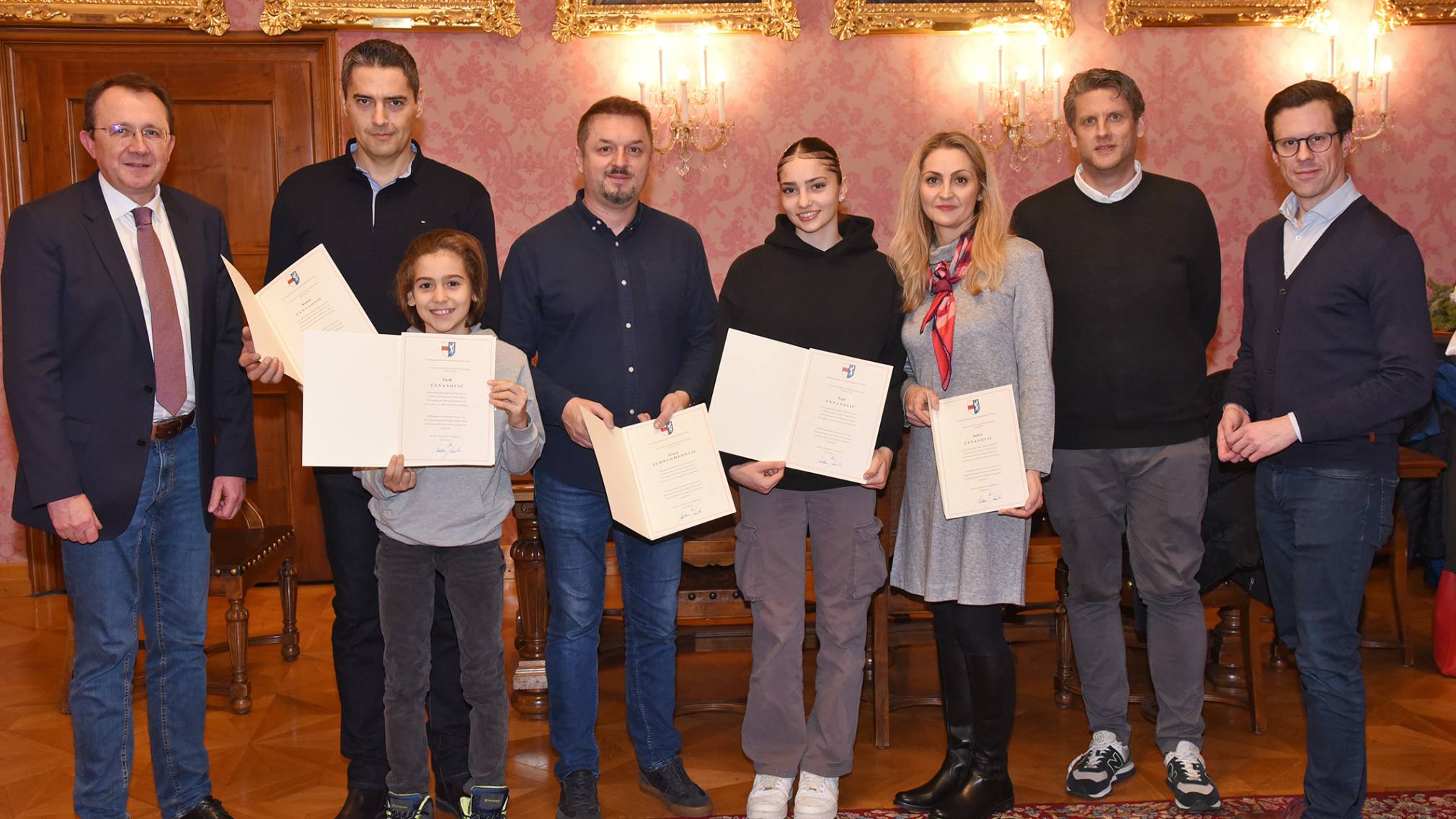 Bürgermeister Matthias Stadler, Kenan Cenanovic, Tarik Cenanovic, Ernest Sehmehmedovic, Nejla Cenanovic, Indira Cenanovic, Referent für Feuerwehren Roland Kormesser und Präsidialabteilungsleiter Michael Koppensteiner bei der Urkundenübergabe. (Foto: Josef Vorlaufer)