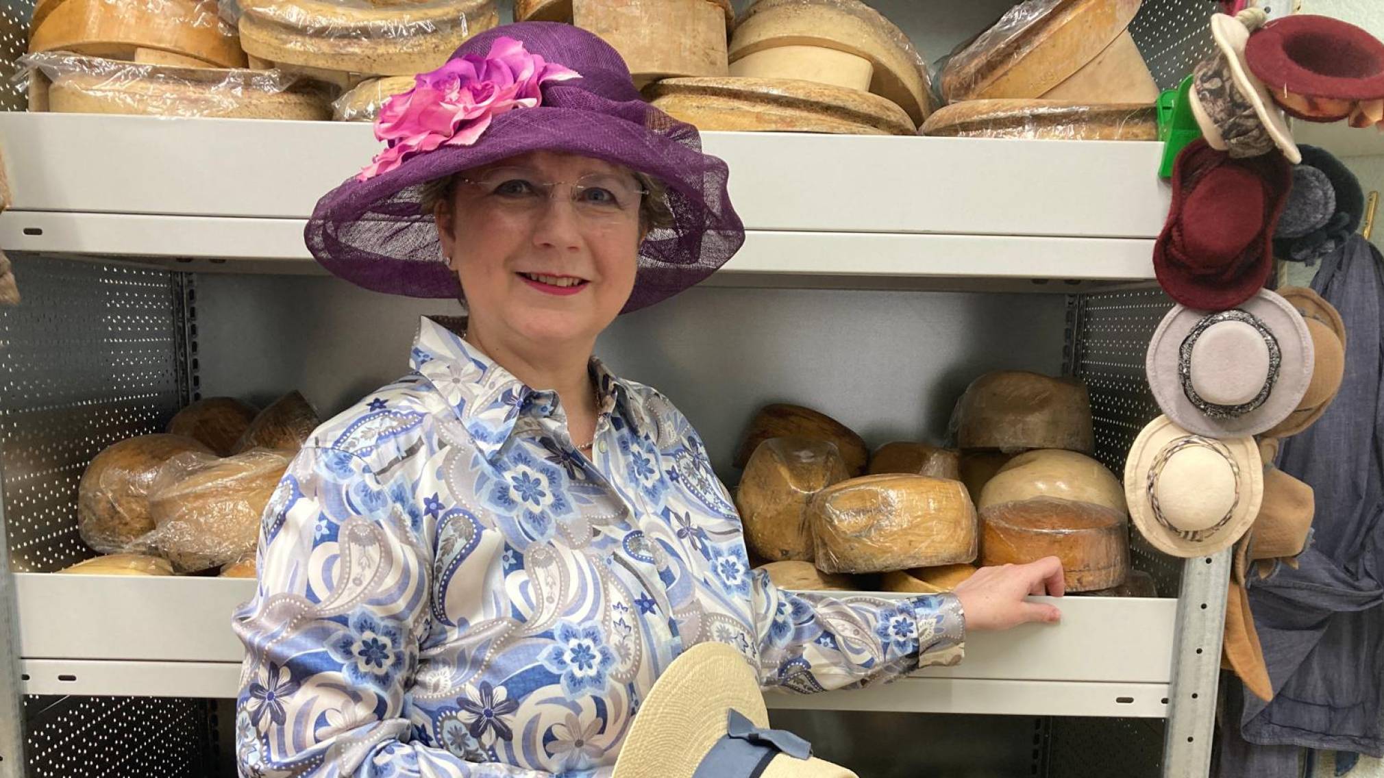 Modisten-Meisterin Anna Öckher vor Regalen voll mit bunten Hüten in ihrem St. Pöltner Geschäft. Foto: Althea Müller